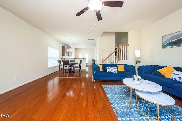1017 Frank Page Dr, Cary, NC 27511 - living area featuring stairs, wood finished floors, a ceiling fan, and baseboards