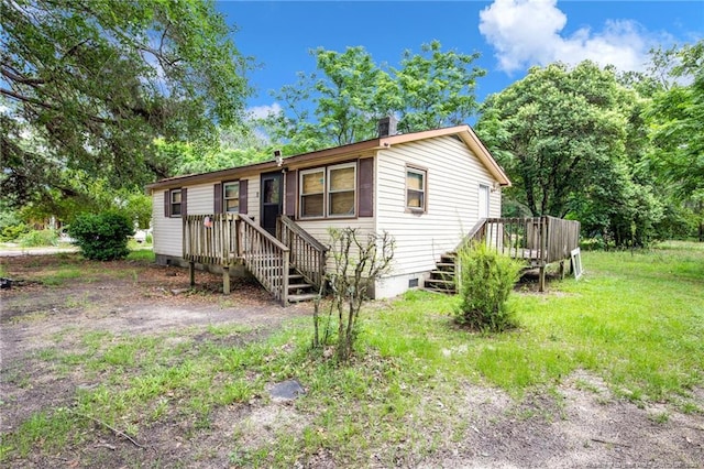 6200 Arabia Rd, Lumber Bridge, NC 28357 - manufactured / mobile home featuring a wooden deck and a chimney