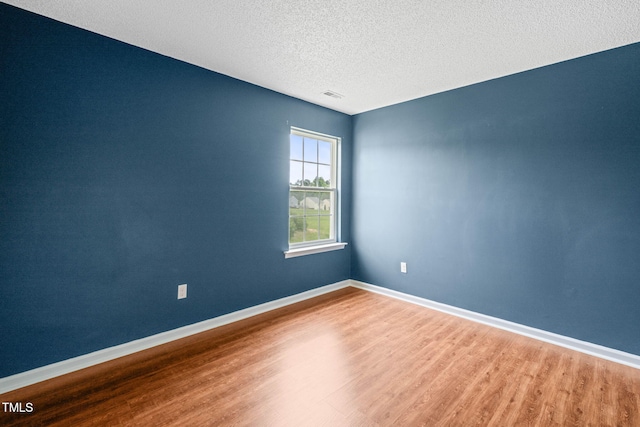 518 Clearfield Dr, Durham, NC 27703 - empty room featuring wood finished floors and a textured ceiling