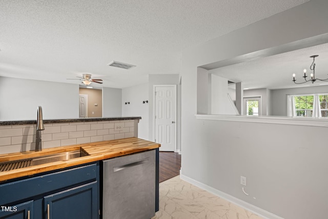 518 Clearfield Dr, Durham, NC 27703 - kitchen featuring blue cabinets, dishwasher, wooden counters, a textured ceiling, and light marble finish floors