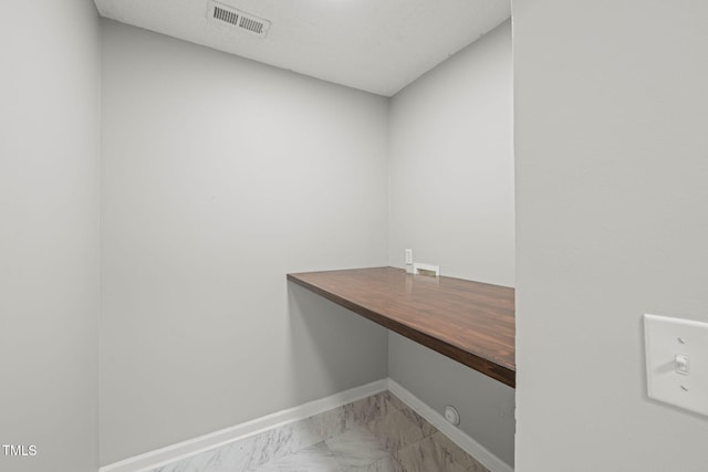 518 Clearfield Dr, Durham, NC 27703 - laundry room with marble look tiles and an office area