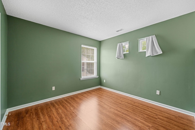 518 Clearfield Dr, Durham, NC 27703 - spare room featuring wood finished floors and a textured ceiling