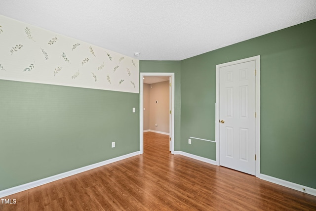 518 Clearfield Dr, Durham, NC 27703 - unfurnished bedroom with wood finished floors and a textured ceiling