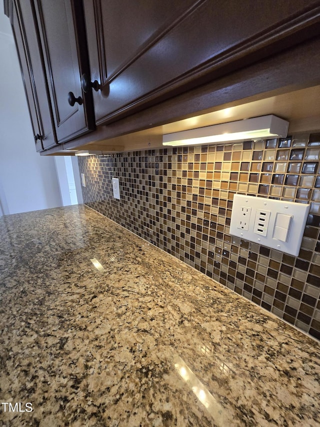 2511 Dalmahoy Ln, Fuquay Varina, NC 27526 - kitchen view of decorative backsplash, stone countertops, and dark brown cabinets