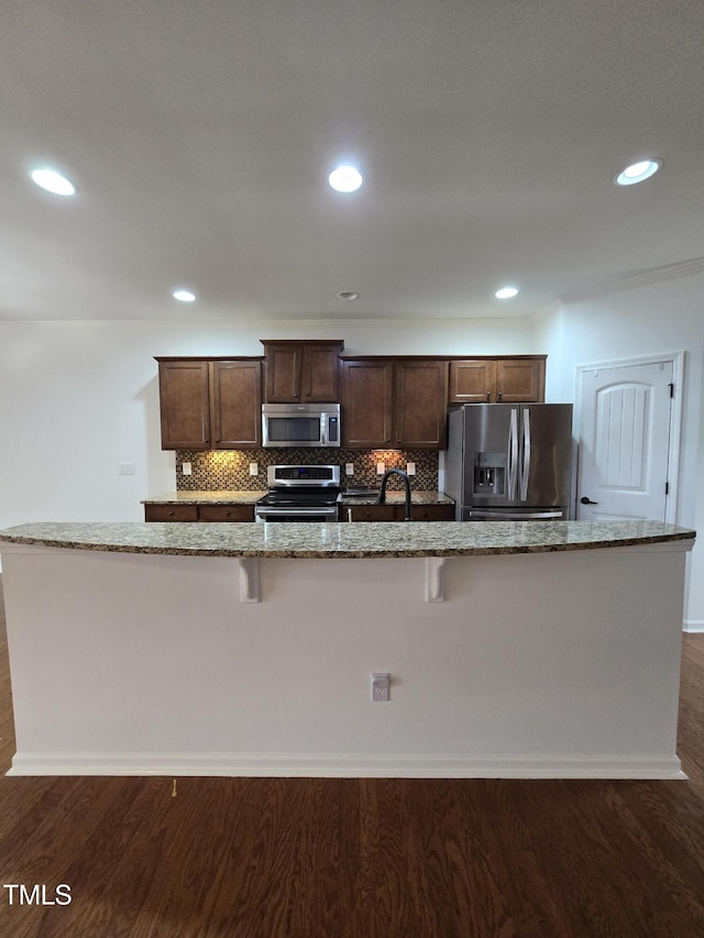 2511 Dalmahoy Ln, Fuquay Varina, NC 27526 - kitchen featuring stainless steel appliances, dark wood finished floors, tasteful backsplash, and recessed lighting