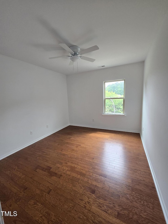 2511 Dalmahoy Ln, Fuquay Varina, NC 27526 - unfurnished room featuring dark wood-style flooring, a ceiling fan, and baseboards