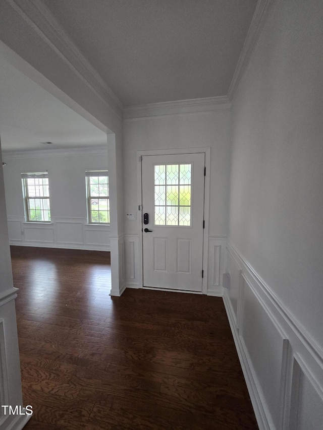 2511 Dalmahoy Ln, Fuquay Varina, NC 27526 - doorway featuring crown molding, dark wood-type flooring, a decorative wall, and a wainscoted wall