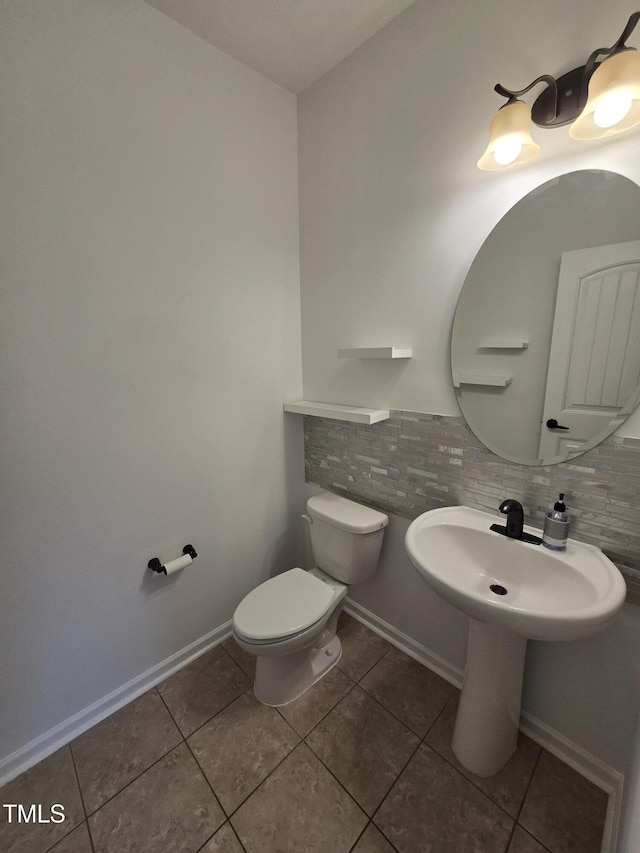 2511 Dalmahoy Ln, Fuquay Varina, NC 27526 - bathroom featuring tile patterned floors, toilet, and tasteful backsplash