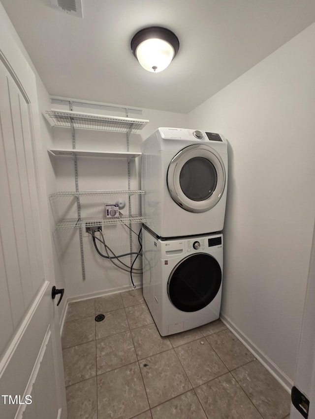 2511 Dalmahoy Ln, Fuquay Varina, NC 27526 - laundry room featuring stacked washer / drying machine, baseboards, and tile patterned floors