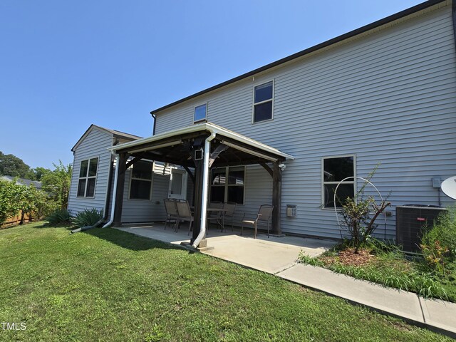 2511 Dalmahoy Ln, Fuquay Varina, NC 27526 - rear view of house featuring central AC unit, a lawn, and a patio area