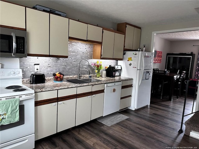 6532 Kemper Ct, Fayetteville, NC 28303 - kitchen featuring white appliances, dark wood-style flooring, tasteful backsplash, light countertops, and a textured ceiling