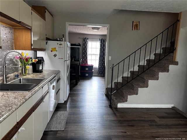 6532 Kemper Ct, Fayetteville, NC 28303 - kitchen with dark wood-style floors, stainless steel dishwasher, backsplash, light countertops, and a textured ceiling