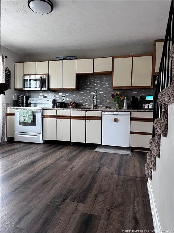 6532 Kemper Ct, Fayetteville, NC 28303 - kitchen with white appliances, dark wood-style floors, tasteful backsplash, white cabinets, and a textured ceiling