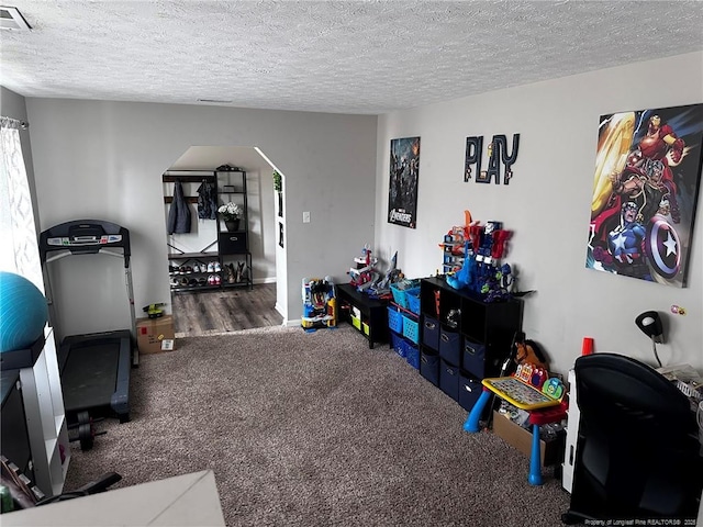 6532 Kemper Ct, Fayetteville, NC 28303 - game room with arched walkways, carpet, and a textured ceiling