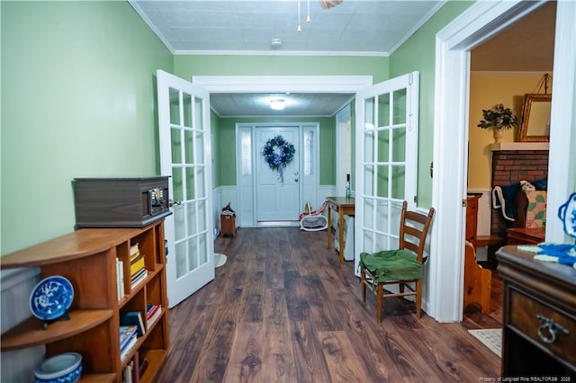 208 W Thompson St E, Fairmont, NC 28340 - entryway with french doors, crown molding, dark wood-type flooring, a wainscoted wall, and a decorative wall