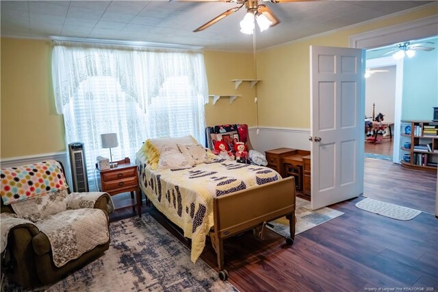 208 W Thompson St E, Fairmont, NC 28340 - bedroom featuring wood finished floors, multiple windows, crown molding, and ceiling fan