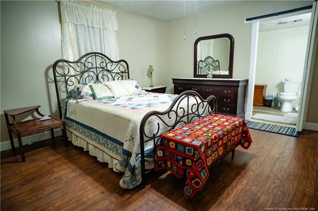208 W Thompson St E, Fairmont, NC 28340 - bedroom with wood finished floors, baseboards, and ensuite bathroom