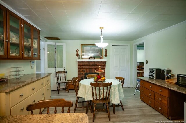 208 W Thompson St E, Fairmont, NC 28340 - dining area with light wood-type flooring and a fireplace