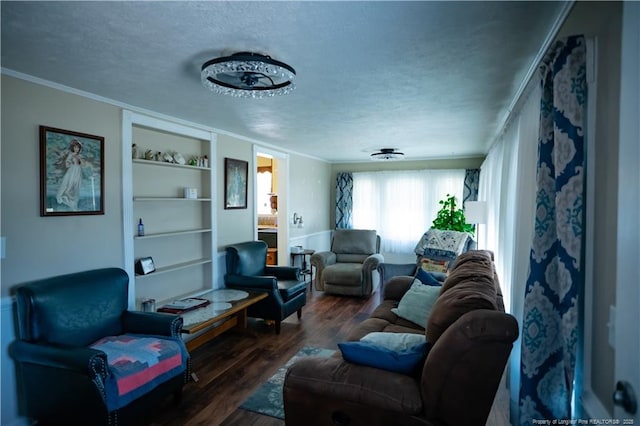 208 W Thompson St E, Fairmont, NC 28340 - living room featuring wood finished floors, crown molding, a textured ceiling, and built in features