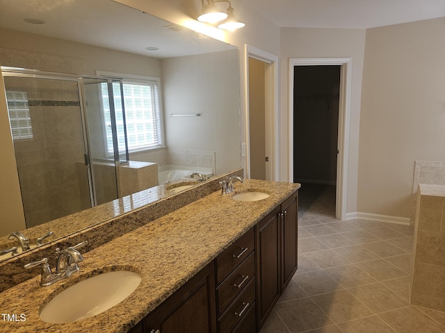 112 Briarfield Dr, Apex, NC 27502 - bathroom with a stall shower, a garden tub, double vanity, tile patterned floors, and baseboards