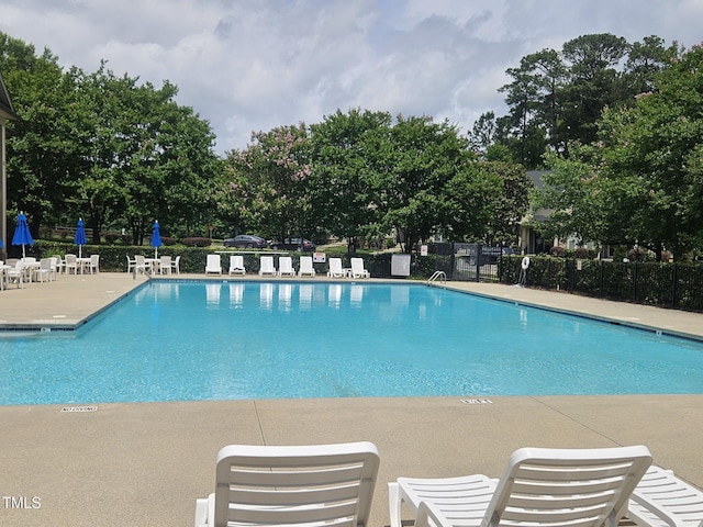 112 Briarfield Dr, Apex, NC 27502 - community pool featuring a patio and view of scattered trees