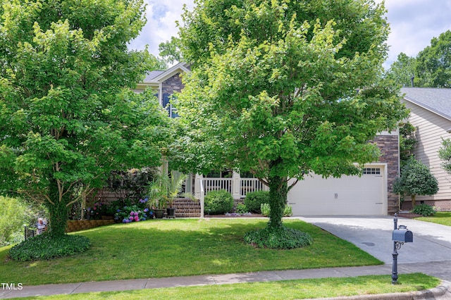 112 Briarfield Dr, Apex, NC 27502 - obstructed view of property with concrete driveway, a front yard, stone siding, and an attached garage