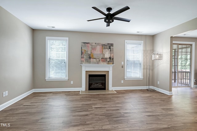 112 Briarfield Dr, Apex, NC 27502 - unfurnished living room featuring wood finished floors, a fireplace with flush hearth, and ceiling fan
