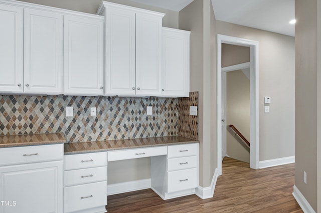 112 Briarfield Dr, Apex, NC 27502 - kitchen with built in study area, backsplash, white cabinets, dark wood finished floors, and recessed lighting
