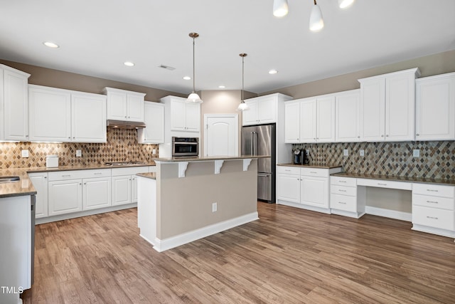 112 Briarfield Dr, Apex, NC 27502 - kitchen featuring stainless steel appliances, backsplash, white cabinets, and recessed lighting