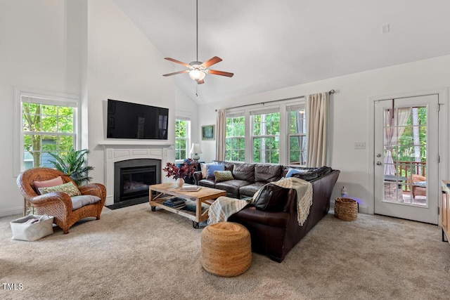 1612 Old Bramble Ln, Fuquay Varina, NC 27526 - carpeted living room featuring high vaulted ceiling, a fireplace with flush hearth, plenty of natural light, and a ceiling fan