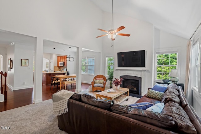 1612 Old Bramble Ln, Fuquay Varina, NC 27526 - carpeted living room with plenty of natural light, a ceiling fan, baseboards, a fireplace with flush hearth, and high vaulted ceiling