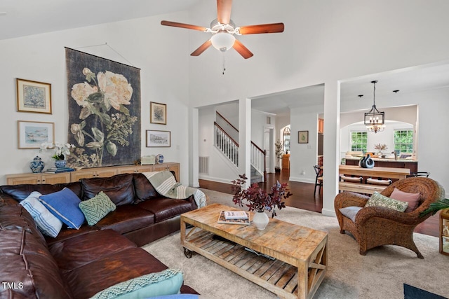 1612 Old Bramble Ln, Fuquay Varina, NC 27526 - living room with stairs, carpet flooring, a ceiling fan, high vaulted ceiling, and baseboards