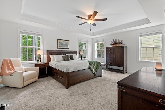 1612 Old Bramble Ln, Fuquay Varina, NC 27526 - bedroom featuring a tray ceiling, multiple windows, light carpet, and a ceiling fan