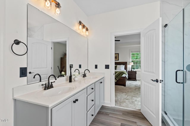 1612 Old Bramble Ln, Fuquay Varina, NC 27526 - ensuite bathroom with double vanity, a stall shower, and wood finished floors