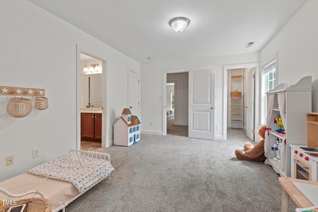 1612 Old Bramble Ln, Fuquay Varina, NC 27526 - bedroom featuring light colored carpet, ensuite bath, baseboards, and a walk in closet