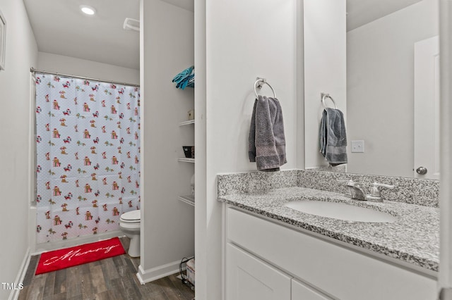 274 E Boulder Rd, Henderson, NC 27537 - full bathroom featuring vanity, toilet, wood finished floors, baseboards, and recessed lighting