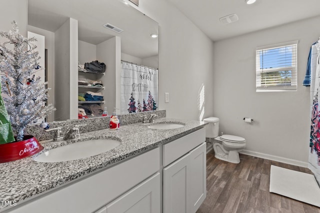 274 E Boulder Rd, Henderson, NC 27537 - full bathroom featuring baseboards, double vanity, toilet, wood finished floors, and a shower with curtain