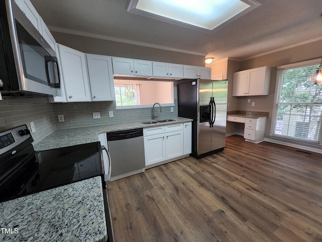 4903 Bridgewood Dr, Durham, NC 27713 - kitchen featuring appliances with stainless steel finishes, a sink, crown molding, white cabinetry, and decorative backsplash