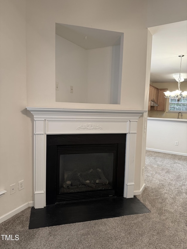 1017 Red Hat Ln, Durham, NC 27713 - detailed view of carpet, a fireplace with flush hearth, a chandelier, and a sink