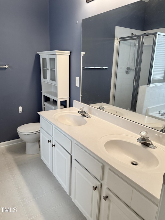 1017 Red Hat Ln, Durham, NC 27713 - full bathroom featuring a stall shower, double vanity, toilet, baseboards, and tile patterned floors