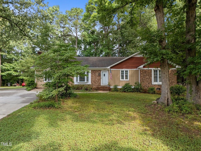 1040 Ivy Ln, Cary, NC 27511 - ranch-style home featuring concrete driveway, a front lawn, brick siding, and a shingled roof