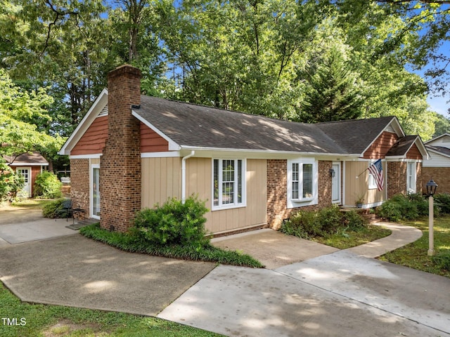 1040 Ivy Ln, Cary, NC 27511 - ranch-style home with a chimney, a shingled roof, and brick siding