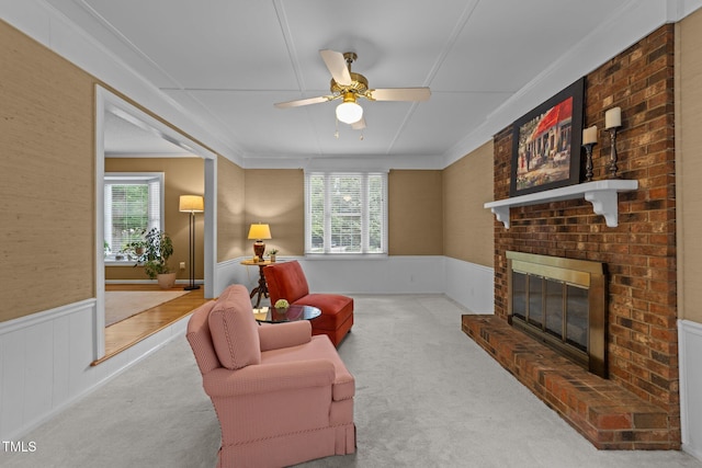 1040 Ivy Ln, Cary, NC 27511 - living area featuring plenty of natural light, a ceiling fan, carpet, wainscoting, and a brick fireplace