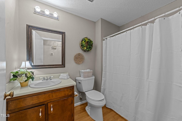 1040 Ivy Ln, Cary, NC 27511 - bathroom with wood finished floors, a textured ceiling, vanity, and a shower with shower curtain