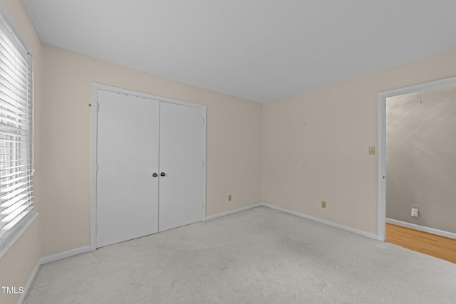 1040 Ivy Ln, Cary, NC 27511 - unfurnished bedroom with carpet, multiple windows, and a closet