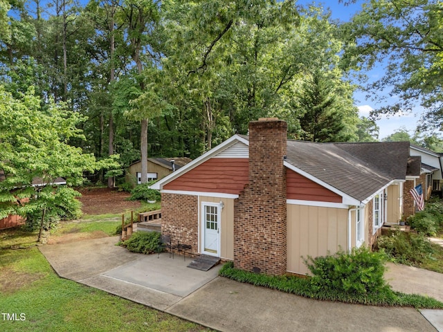 1040 Ivy Ln, Cary, NC 27511 - view of front facade featuring a chimney and a patio area