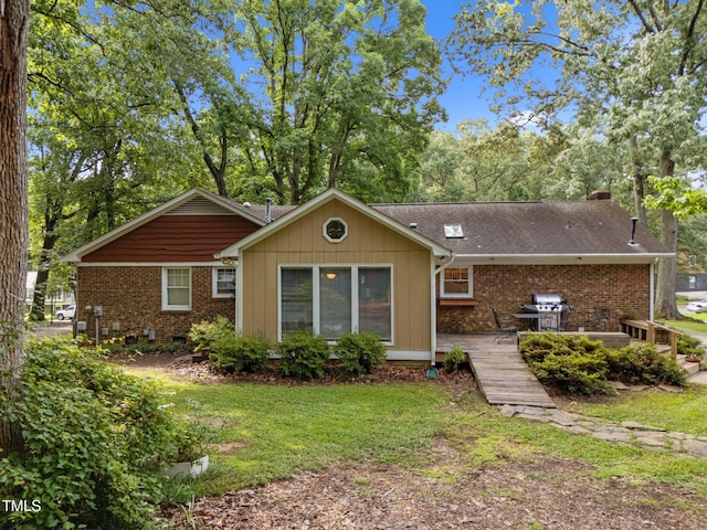 1040 Ivy Ln, Cary, NC 27511 - rear view of property featuring brick siding, a yard, and a shingled roof