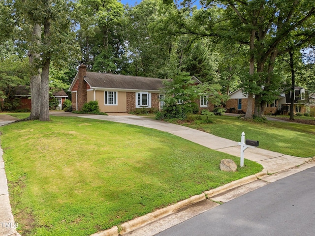1040 Ivy Ln, Cary, NC 27511 - single story home featuring a chimney, brick siding, a front lawn, and driveway