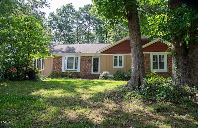 1040 Ivy Ln, Cary, NC 27511 - ranch-style house featuring a front lawn, brick siding, and board and batten siding