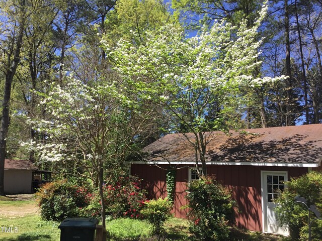 1040 Ivy Ln, Cary, NC 27511 - view of front of home with an outbuilding and a shingled roof